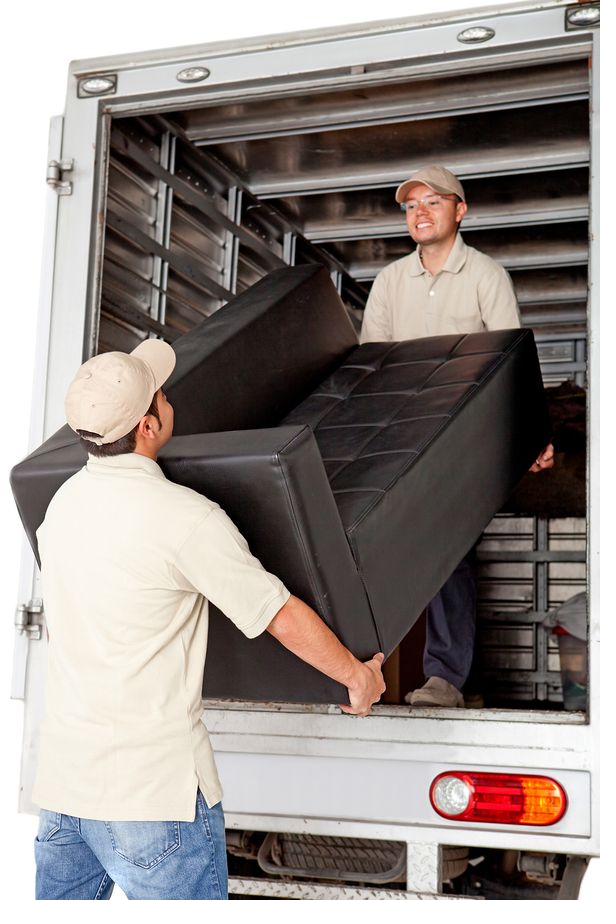 Two JLopez movers loading a couch into a moving truck